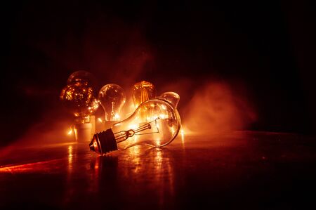 Beautiful retro luxury light lamp decor glowing. Abstract dark background with creative artwork decoration of glowing bulbs.の写真素材