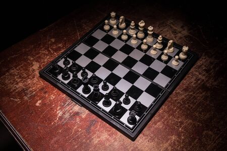 Chess board game concept of business ideas and competition. Chess figures on a dark background with...
