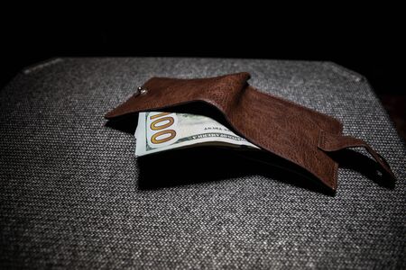 Stylish men's purse with money on wood background. men's purse with money, credit and debit cards on...