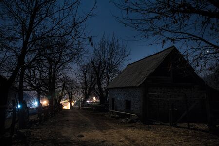 Full moon over quiet village at night. Beautiful night landscape of mountain village under the moonlight. Azerbaijan nature. Long exposure shotの写真素材