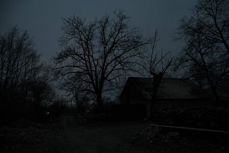 Full moon over quiet village at night. Beautiful night landscape of mountain village under the...