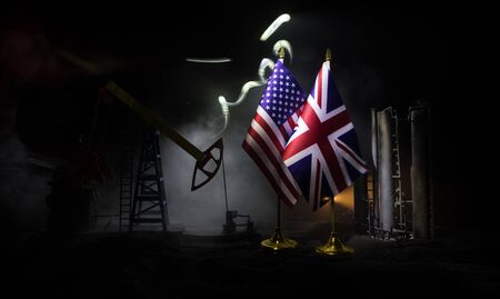 Business dialogue, oil agreement concept: National flags with Oil pump and oil refining factory at...