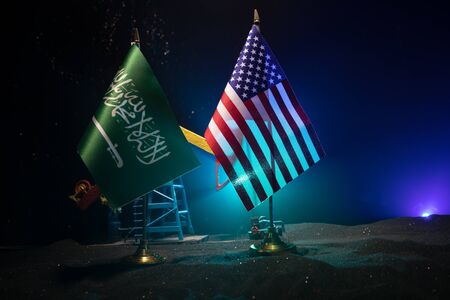 Business dialogue, oil agreement concept: National flags with Oil pump and oil refining factory at night. Energy industrial concept. Selective focus. Artwork decoration.の写真素材