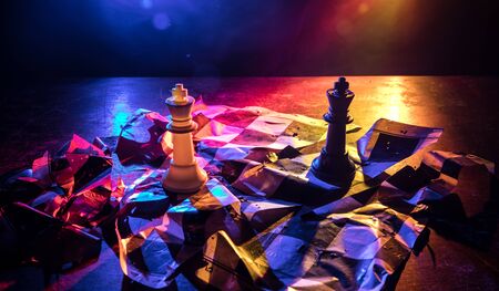 Chess board game concept of business ideas and competition. Chess figures on a dark background with broken chessboard. Creative artwork decoration. Selective focusの写真素材