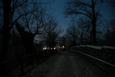 Full moon over quiet village at night. Beautiful night landscape of mountain village under the...