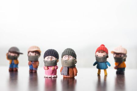 Miniature people : Citizens wearing masks to protect against viruses. People wear masks to prevent New type COVID-19 pneumonia. Coronavirus and Covid-19 concept. Selective focusの写真素材