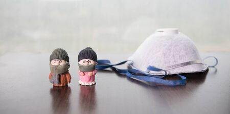 Miniature people : Citizens wearing masks to protect against viruses. People wear masks to prevent New type COVID-19 pneumonia. Coronavirus and Covid-19 concept. Selective focusの写真素材