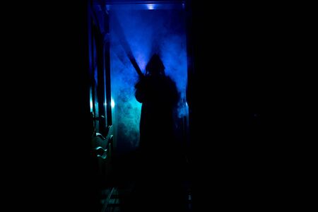 Silhouette of an unknown shadow figure on a door through a closed glass door. Spooky silhouette girl...