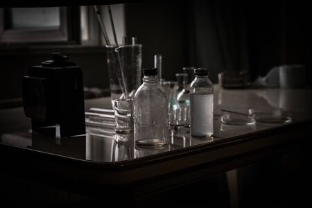 medical glass in school laboratory in front of window. Dark Room. Selective focus