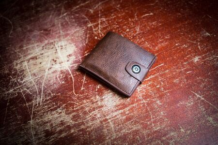 Stylish men's purse with money on wood background. men's purse with money, credit and debit cards on...