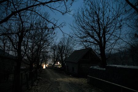 Full moon over quiet village at night. Beautiful night landscape of mountain village under the moonlight. Azerbaijan nature. Long exposure shotの写真素材