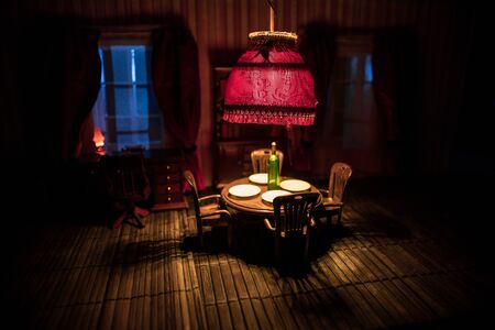 A realistic dollhouse living room with furniture and window at night. Artwork table decoration with...