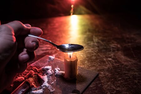 Narcotic drug problem concept. Drug syringe and narcotic attributes on wooden table. Purchase, possession and sale of drugs is punishable by law. Creative artwork decorationの写真素材