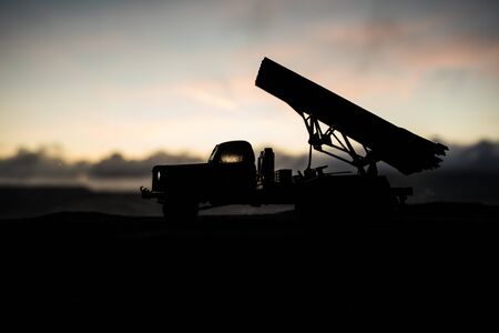 Rocket launch with fire clouds. Battle scene with rocket Missiles with Warhead Aimed at Gloomy Sky at sunset. Soviet rocket launcher on War Background. Creative composition.の素材 [FY310144612751]