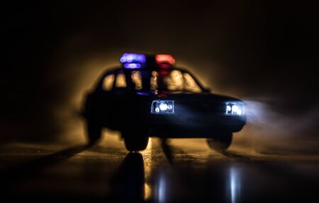 Corona virus concept with police. Stay home for precautionary measures to prevent from corona virus. Anti-riot police give signal to be ready. Smoke on a dark background with lights. Selective focusの写真素材