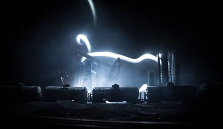 Oil pump and oil refining factory at night with fog and backlight. Energy industrial concept. Night...