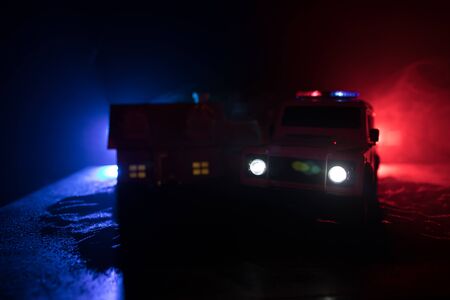 Corona virus concept with police. Stay home for precautionary measures to prevent from corona virus. Anti-riot police give signal to be ready. Smoke on a dark background with lights. Selective focusの写真素材