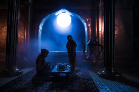 A realistic Arabian interior miniature with window and columns. Meals are served before sunrise called Suhur. Festive greeting card, invitation for Muslim holy month Ramadan Kareem. Selective focusの写真素材