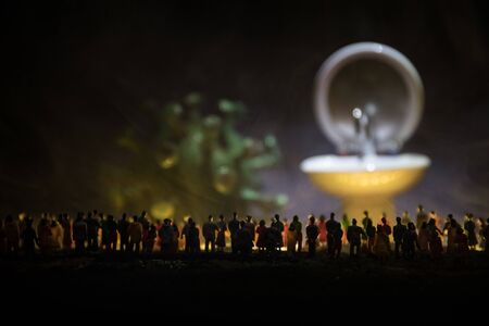 Miniature crowd looking to washstand on dark background. Hygiene concept. Wash hands protect yourself. Corona virus Prevention. Selective focusの写真素材