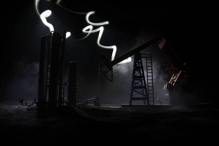Oil pump and oil refining factory at night with fog and backlight. Energy industrial concept....