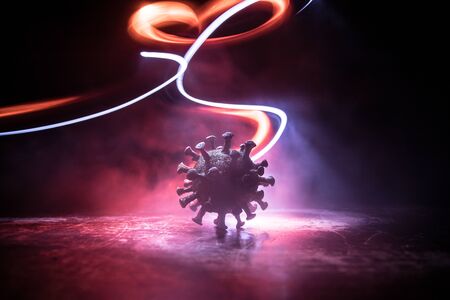 Coronavirus 2019-nCov novel coronavirus concept. Big Corona virus miniature model on wooden table...