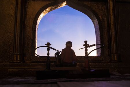 Shisha concept. A realistic Arabian interior miniature with window and columns. Hookah hot coals on...