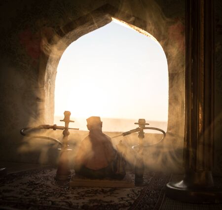 Shisha concept. A realistic Arabian interior miniature with window and columns. Hookah hot coals on...