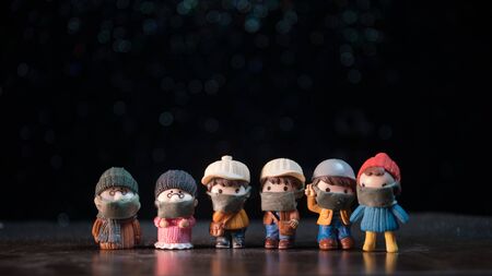 Miniature people : Citizens wearing masks to protect against viruses. People wear masks to prevent New type COVID-19 pneumonia. Coronavirus and Covid-19 concept. Selective focusの写真素材