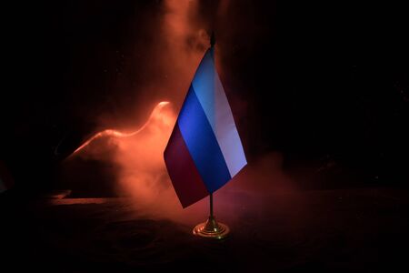 Business dialogue, oil agreement concept: National flags with Oil pump and oil refining factory at night. Energy industrial concept. Selective focus. Artwork decoration.の写真素材