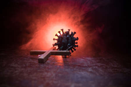 Creative concept of manipulation with coronavirus. Covid19 miniature with strings on a dark...