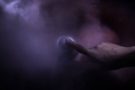 Calling service bell on wooden table with toned lights on dark background. Hotel reception bell,...