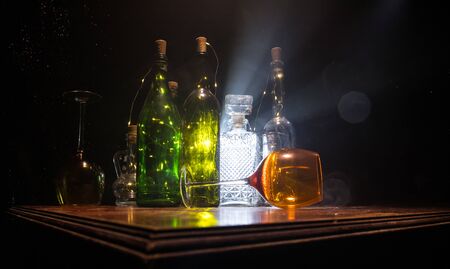Goblet of wine on wooden table with beautiful toned lights on background. Glasses of wine on dark background. Selective focus. Club drink conceptの写真素材