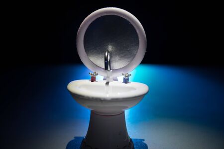Miniature washstand on dark background. Hygiene concept. Wash hands protect yourself. Corona virus Prevention. Selective focusの写真素材