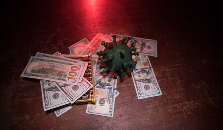 Corona virus global economy crisis concept. Corona virus miniature, money and abacus on wooden table...