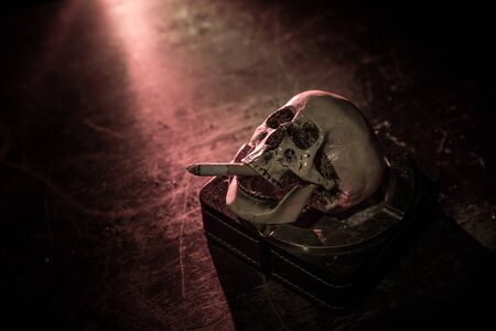 No smoking concept. Creative artwork table decoration with cigarettes. Cigarettes cause cancer and...