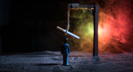 No smoking concept. Creative artwork table decoration with cigarettes. Cigarettes cause cancer and kill. Hanged cigarette on scaffoldの写真素材