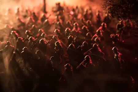 War Concept. Military silhouettes fighting scene on war fog sky background, World War Soldiers Silhouette Below Cloudy Skyline At night. Battle in ruined city. Selective focusの写真素材