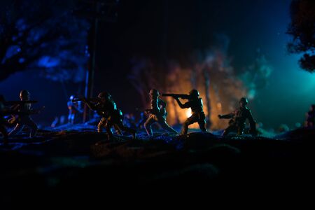 War Concept. Military silhouettes fighting scene on war fog sky background, World War Soldiers Silhouette Below Cloudy Skyline At night. Battle in ruined city. Selective focusの写真素材