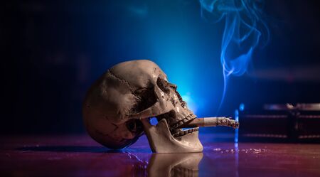 No smoking concept. Creative artwork table decoration with cigarettes. Cigarettes cause cancer and kill. still life skull and sigarette. Selective focusの写真素材