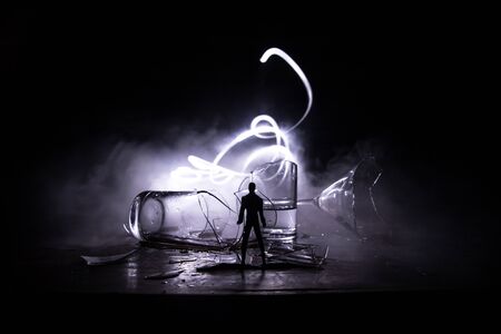 Drink, broken glass concept. Creative artwork decoration. Silhouette of a man standing at the broken...