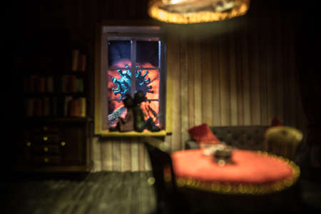 A realistic dollhouse living room with furniture and window at night. Stay home stay safe coronavirus concept. Selective focus.の写真素材