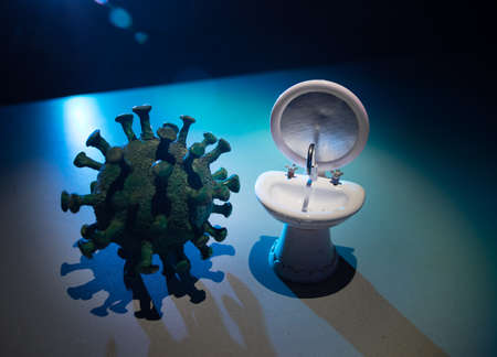 Miniature washstand on dark background. Hygiene concept. Wash hands protect yourself. Corona virus Prevention. Selective focusの写真素材