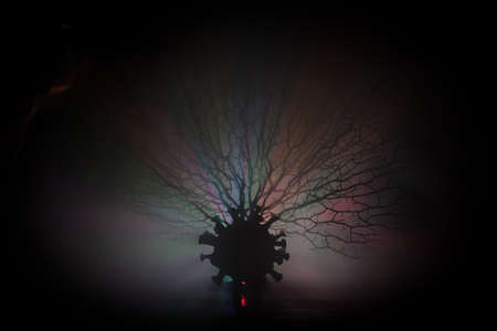 Coronavirus 2019-nCov novel coronavirus concept. Big Corona virus miniature model on wooden table...