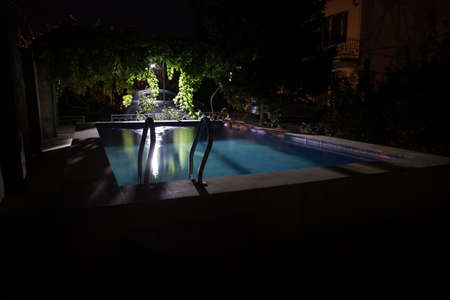 Pool at night - vacation background. Colorful light decoration. Freezelightの写真素材