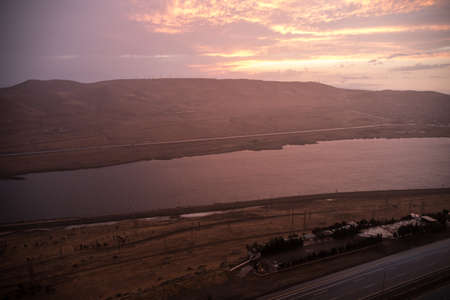 Beautiful clouds flying over the lake near mountains. Evening time shot over the clouds. Baku,...