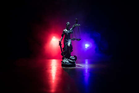 Law concept. Miniature colorful artwork decoration with fog and backlight. The Statue of Justice - lady justice or Iustitia / Justitia the Roman goddess of Justice. Selective focusの写真素材