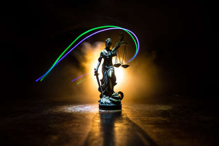 Execution concept. Death penalty guillotine miniature inside old prison. Old prison bars cell lock. Man inside jail. Horror view of Guillotine scale model in the darkの写真素材