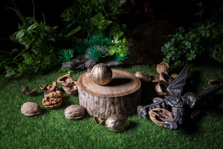 Still life with Walnut kernels and whole walnuts on green grass Creative table decoration. Closeup....