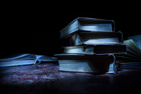 Halloween pumpkin smile and scary eyes for party night. Close up view of scary Halloween pumpkin with eyes glowing inside at black background. Selective focusの写真素材