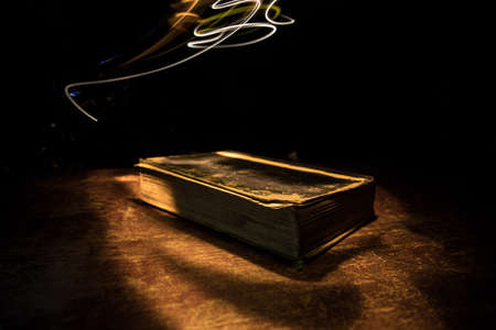 Halloween pumpkin smile and scary eyes for party night. Close up view of scary Halloween pumpkin with eyes glowing inside at black background. Selective focusの写真素材